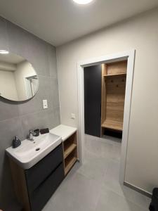 a bathroom with a sink and a mirror at AVA apartmán Javorná na Šumavě in Čachrov +7 photos