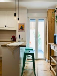 a green stool sitting at a counter in a kitchen at Casa Jazmin in Alora