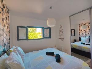 a bedroom with a bed with a bag on it at À la Volette - Cosy, Nature & Miel des Vosges in Plombières-les-Bains