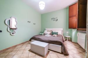 a bedroom with a bed and a table and a mirror at La Casetta del Suffragio in Viterbo