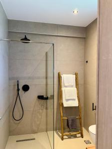 a glass shower with a towel rack in a bathroom at Skiathos Bliss Villa in Skiathos +38 photos