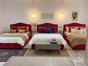 two beds in a room with red furniture at Lizz-Hotel in Chişinău