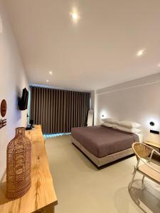 a bedroom with a bed and a table in it at Skiathos Bliss Villa in Skiathos