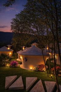 a house with lights in the yard at night at Divlja dolina in Budva +7 photos