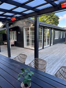 a patio with a table and chairs on a deck at The Copenhagen Retreat in Hvidovre