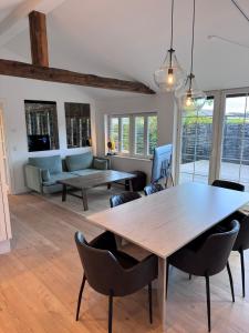 a living room with a wooden table and chairs at The Copenhagen Retreat in Hvidovre