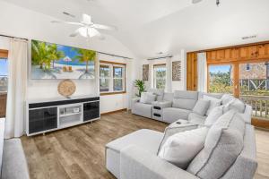 a living room with a couch and a tv at 8055 - Down By The Dunes in Rodanthe