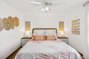 a white bedroom with a bed with two night stands at 8055 - Down By The Dunes in Rodanthe