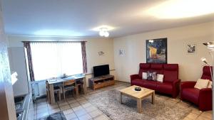 a living room with a red couch and a table at Ferienwohnung 3 in Bernkastel-Kues