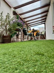 a patio with chairs and a table on the grass at Ferienwohnung 3 in Bernkastel-Kues