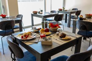 a table with plates of food on it at B&B Abbazia di Piona in Colico