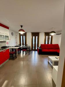 a living room with a red couch and a table at O LAR DE MARTINA in Redondela