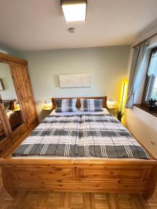 a bedroom with a large wooden bed in a room at Ferienwohnung mit Kamin - Hunde willkommen in Falkenstein +19 photos