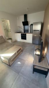 a living room with a bed and a kitchen at Studio 145 E in Douai