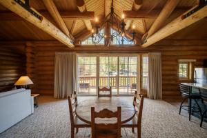 a living room with wooden ceilings and a large window at Rock Creek Resort in Red Lodge