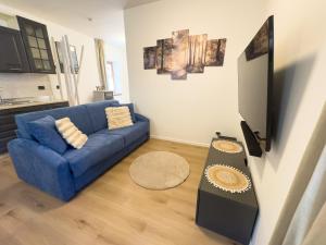 a living room with a blue couch and a table at Casa del Torchio in Giovo