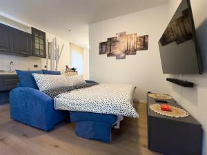 a living room with a blue couch and a table at Casa del Torchio in Giovo