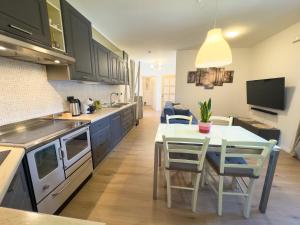 a kitchen and dining room with a table and chairs at Casa del Torchio in Giovo