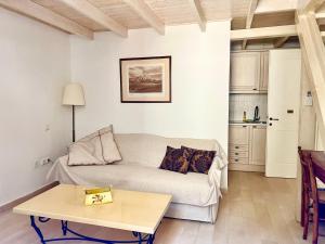 a living room with a couch and a table at PortaDelMare deluxe suites in Hydra