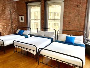 three beds sitting in a room with windows at Empire State & nest in New York +34 photos