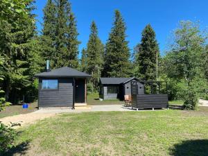 a cabin in a park with a grass field at Cottage in Raahe in Raahe