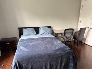a bedroom with a bed and a table and chairs at Modern House in Toronto in Toronto