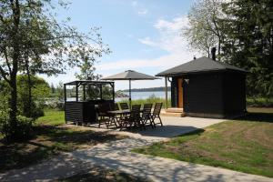 a gazebo with a table and chairs and a table and chairsktop at Cottage in Raahe in Raahe