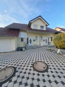 a house with two manholes in front of it at Mng home in Kippenheim