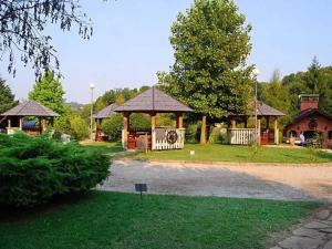 a gazebo and a pavilion in a park at Vila PAUN in Doboj