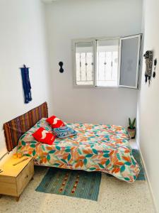 a bedroom with a bed and a window at Dar D'Art in Tunis
