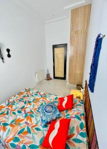 a bed with a colorful comforter in a bedroom at Dar D'Art in Tunis