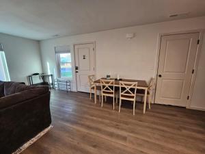 a living room with a table and chairs and a couch at Southern Charm on Earl in Stanfield