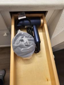 a black charger and a white bag in a drawer at Southern Charm on Earl in Stanfield