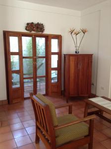 a living room with a chair and a table at La Casa de Don Santiago Townhouse in Copan Ruinas