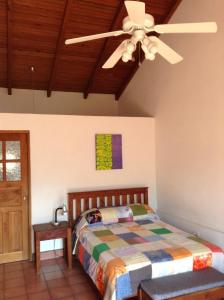 a bedroom with a bed and a ceiling fan at La Casa de Don Santiago Townhouse in Copan Ruinas