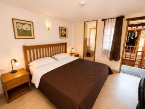 a bedroom with a large bed and a window at Hostal La Candelaria in Bogotá