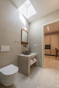 a bathroom with a toilet and a skylight at PEA Plaka Authentic Home in Plaka Milou