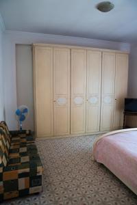 a bedroom with a bed and some closets at Casa Gordon Riviera in Terracina