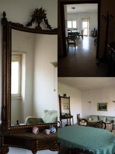 a room with a mirror and a living room with a table at Casa Gordon Riviera in Terracina