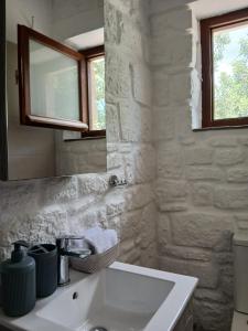 a white bathroom with a sink and a mirror at Egina Home in Egina +16 photos