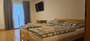 a bedroom with two beds with two laptops on them at Penzion Bernardýn in Bořetice