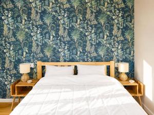 a bedroom with a bed with a blue and green wallpaper at Panorama - Lake Maggiore House in Colazza +13 photos