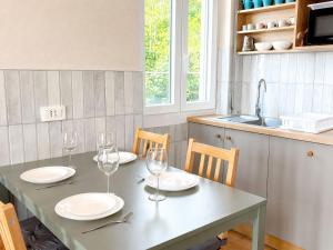 a table with plates and wine glasses on it at Panorama - Lake Maggiore House in Colazza