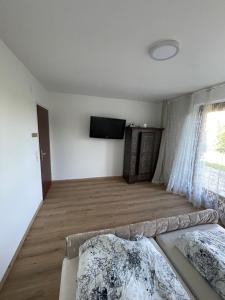 a living room with a couch and a flat screen tv at Private Garden Apartment near Bad Schallerbach in Wallern an der Trattnach