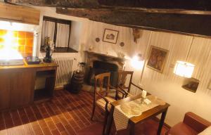 a living room with a table and a fireplace at Helle Sonne in Agarone
