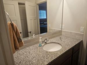 a bathroom counter with a sink and a mirror at Cozy 2BR Home Parking Full Kitchen in Stanfield +11 photos