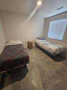 a bedroom with two beds and a window at Cozy 2BR Home Parking Full Kitchen in Stanfield