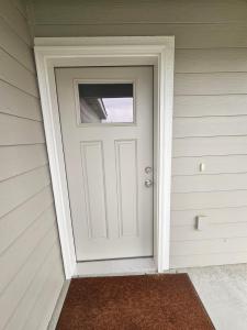 a white door on the side of a house at Cozy 2BR Home Parking Full Kitchen in Stanfield