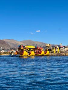 a group of yellow rafts on a body of water at Titicaca House Mariela in Puno