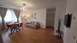 a living room with a table and a couch at Cristina Home in Alba Iulia
